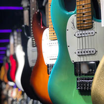 a picture of some electric guitars lined up.
